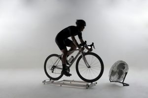 man in black t-shirt riding on orange and black bicycle